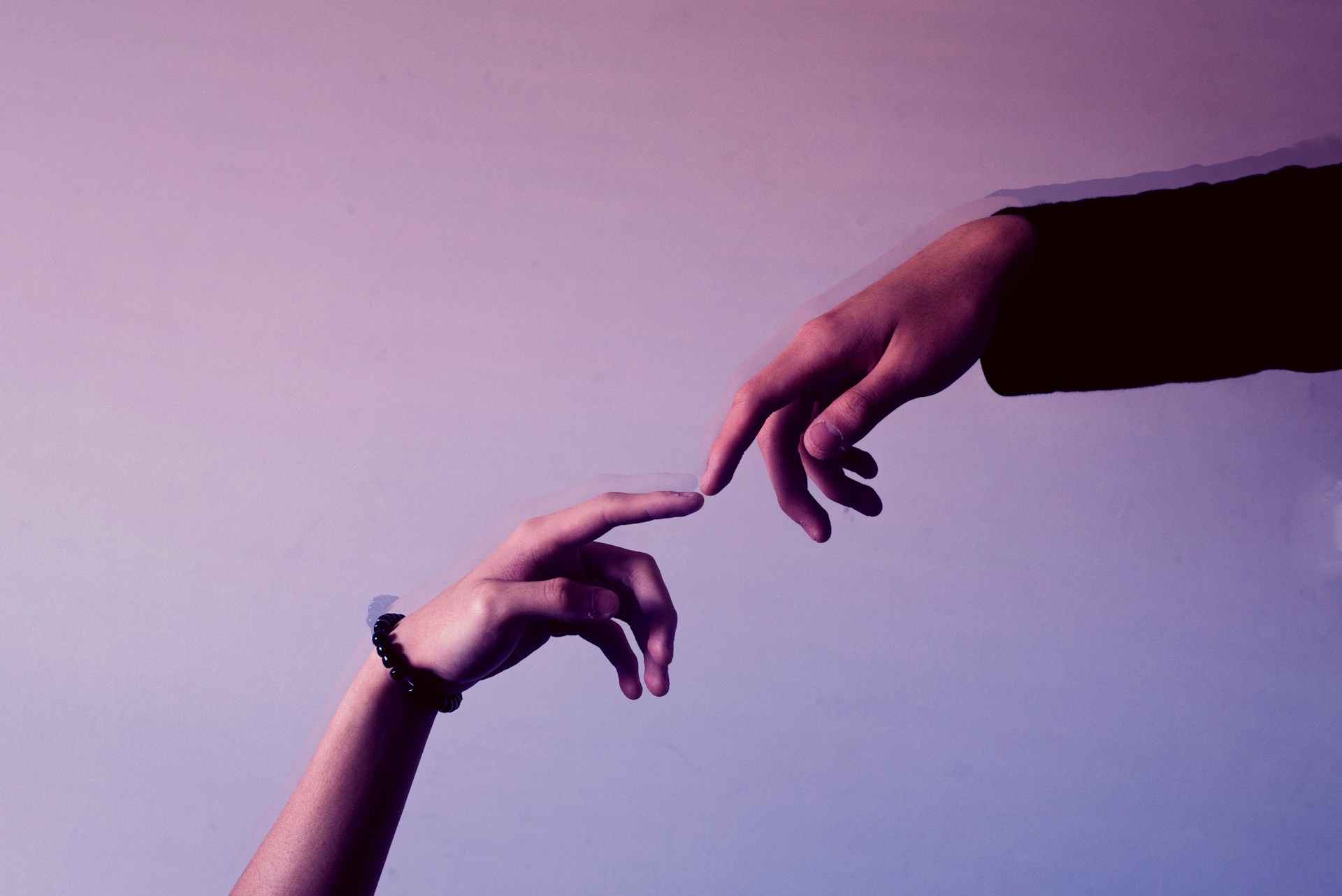 Two hands reaching for one another.